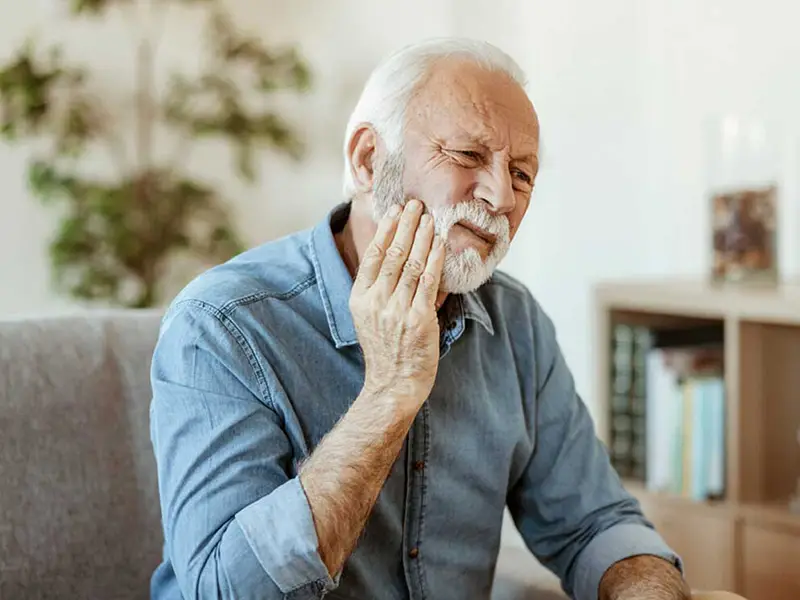 Older male having tooth pain