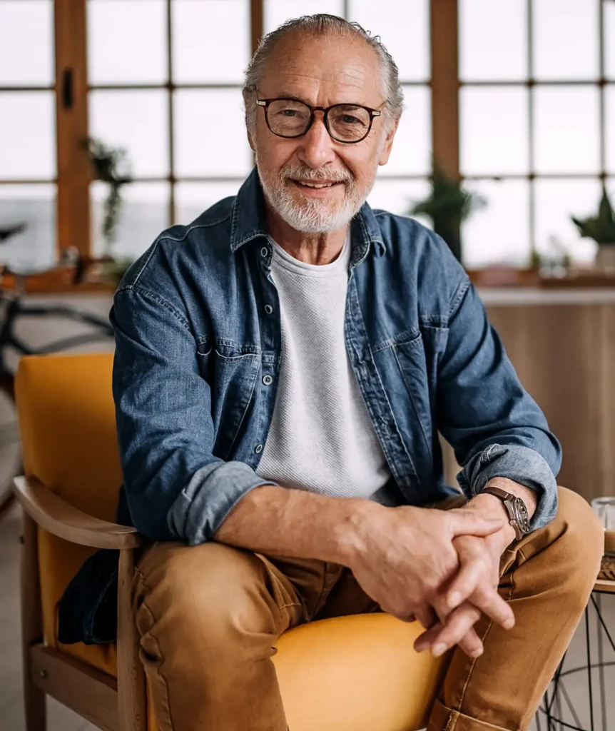 Older man in glasses smiling