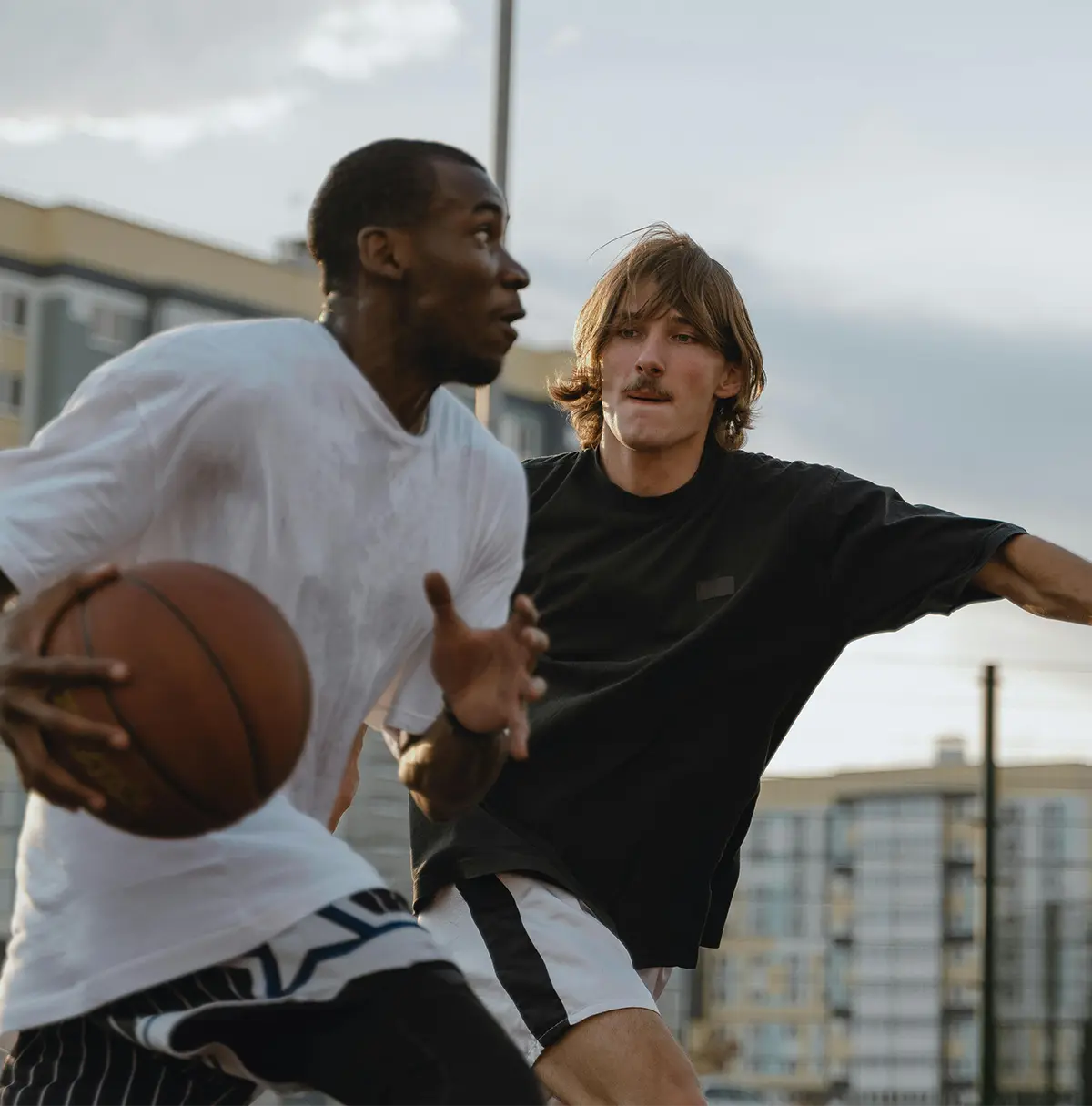 Two men playing basketball